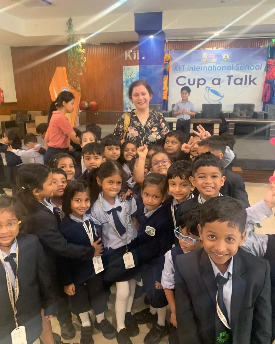 Shefali Chopra surrounded by young students at KiiT International School